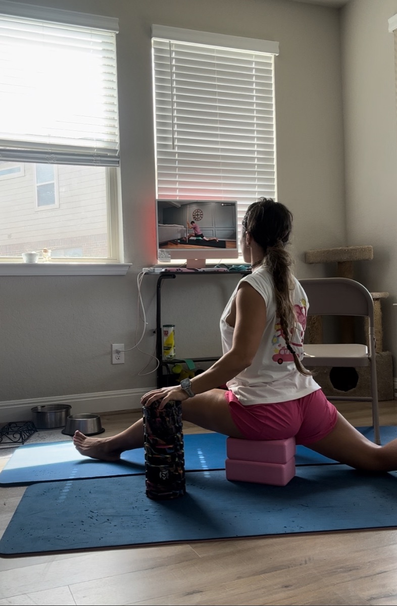 Supple Warriors member training a seated straddle at home